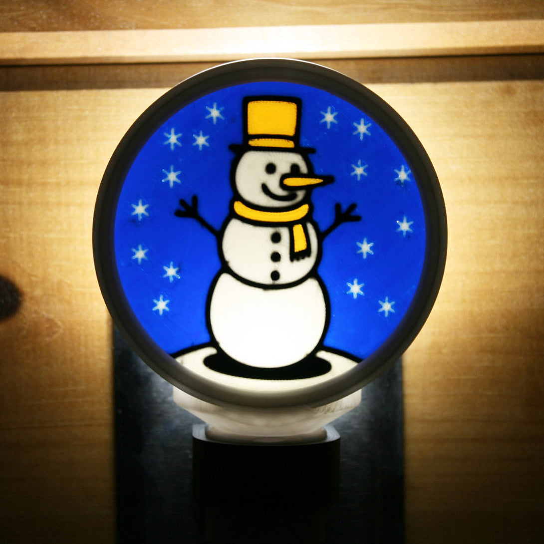 Decorative night light with a snowman design on a blue background 3d printed.