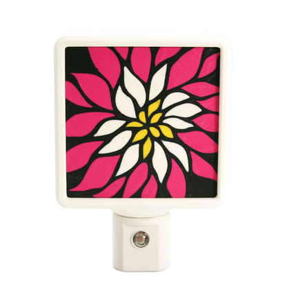 Colorful floral night light with pink, white, and yellow design on a black background.